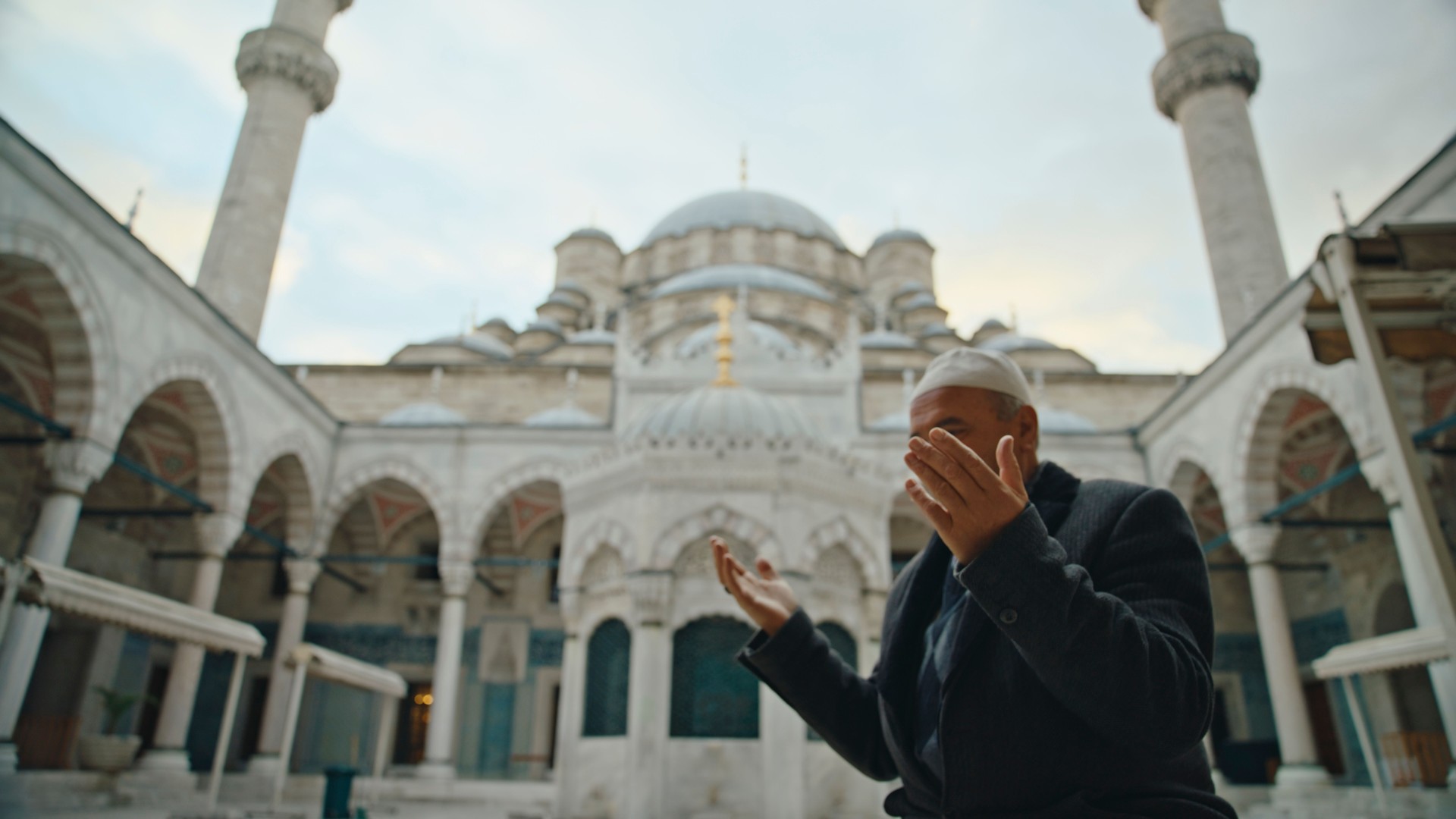 Low Angle View of Mature Man Praying at Courtyard of Blue Mosque against Sky at Istanbul,Turkey